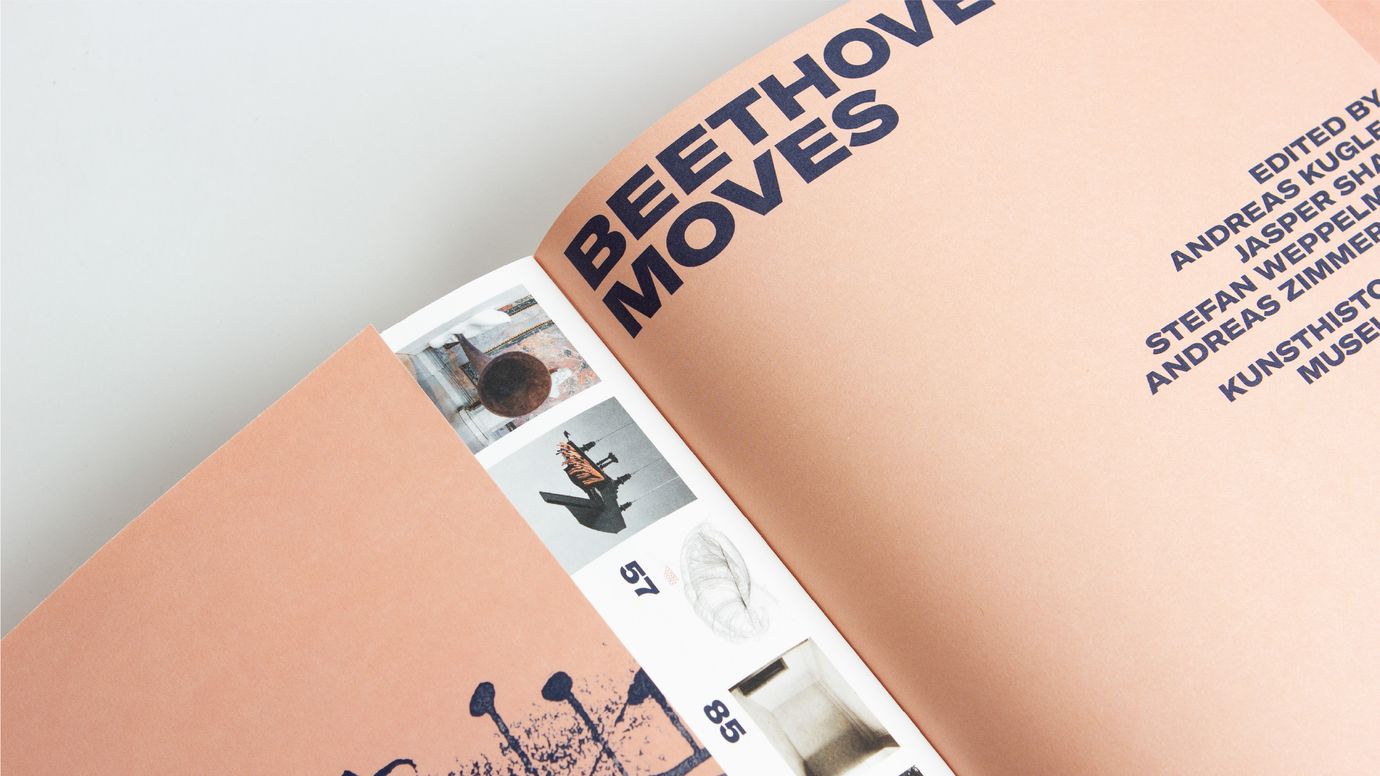 The title 'BEETHOVEN MOVES' is prominently displayed in all caps on the right side of a book cover. Dark blue type on a salmon-colored background. On the first page, to the left and partially hidden by the flap, a glimpse of the table of contents with small thumbnails is visible.